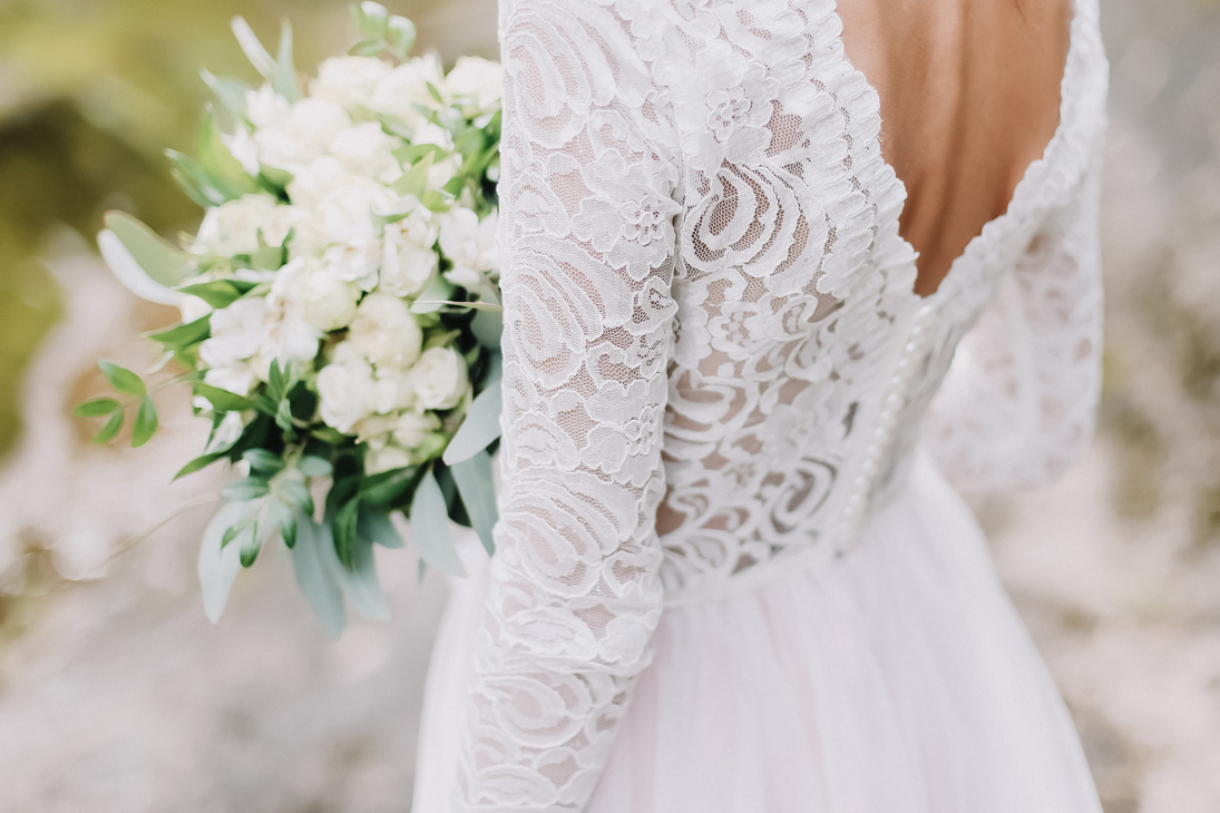 Bride holds a wedding bouquet, wedding dress, wedding details