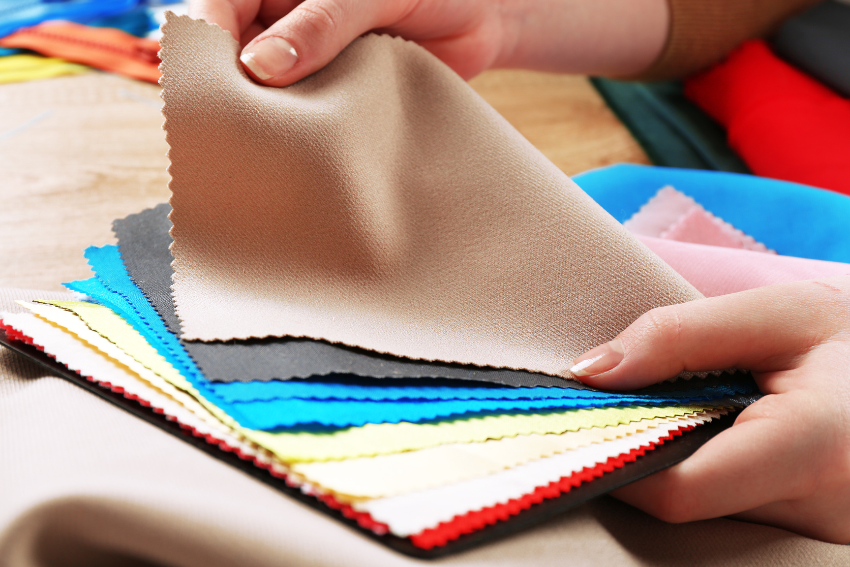 Person Choosing from Colorful Fabric Samples